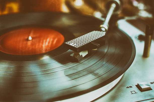The vinyl record player is playing music.