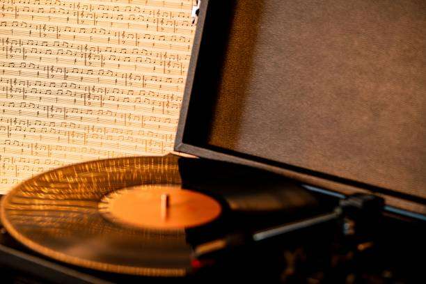 Where does the warmth of a vinyl record player's sound come from